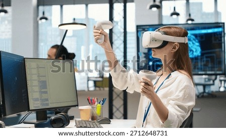 Junior dev using virtual reality at work, testing generative AI machine learning algorithms. Young woman wearing VR goggles equipment scaling productivity with AI large language model code, camera A