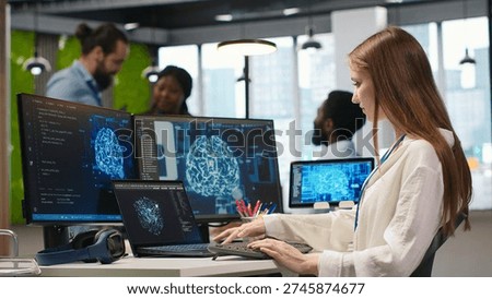 Junior developer in office integrating AI machine learning systems to streamline workflows. Young employee uses neural networks artificial intelligence, technology overload concept, camera A