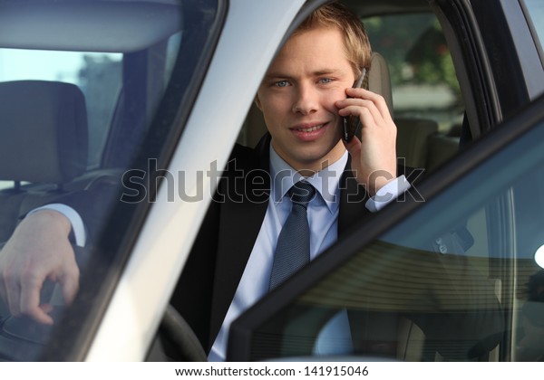 junior executive driving\
luxury car