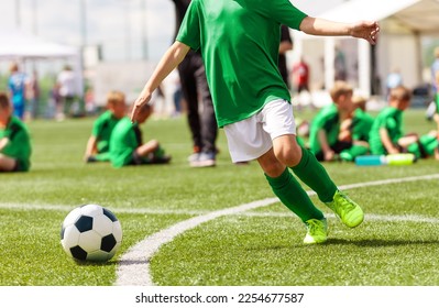 Junior football player in the school stadium. Young boy running and kicking soccer ball - Shutterstock ID 2254677587