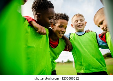 Junior football team huddling together - Powered by Shutterstock