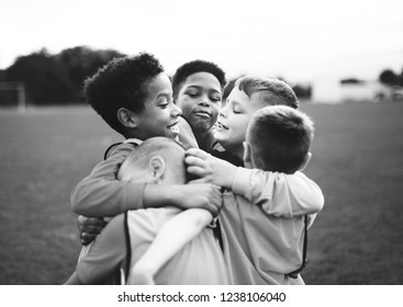 Junior Football Team Hugging Each Other