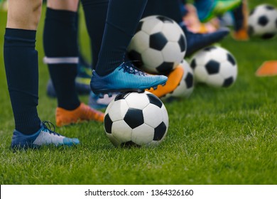 Junior Football Training Session. Players Standing in a Row with Classic Black and White Balls. Youths Practice on Soccer Field. Low Angle Close-up Image of Soccer Boys. Football Education Background