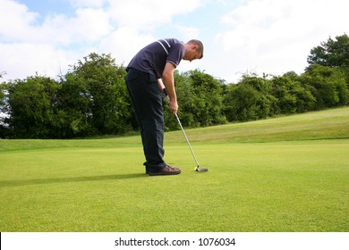 A Junior Golf Champion Putts In For A Birdie