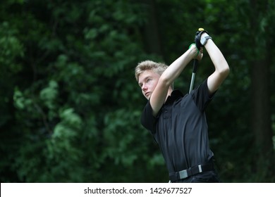 A Junior Golf Hits A Golf Shot