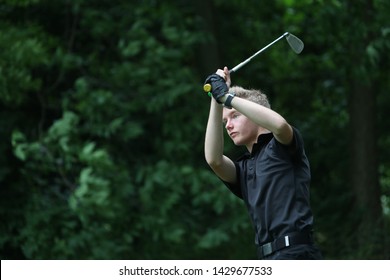 A Junior Golf Hits A Golf Shot