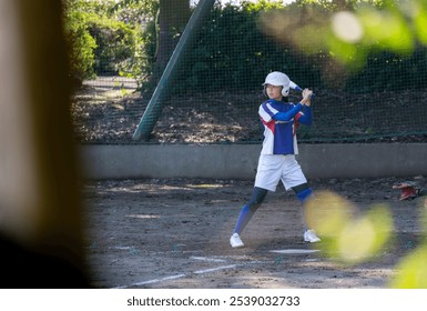 Junior high school girl playing softball batter - Powered by Shutterstock