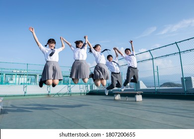 Junior High School Students Jumping On The Roof