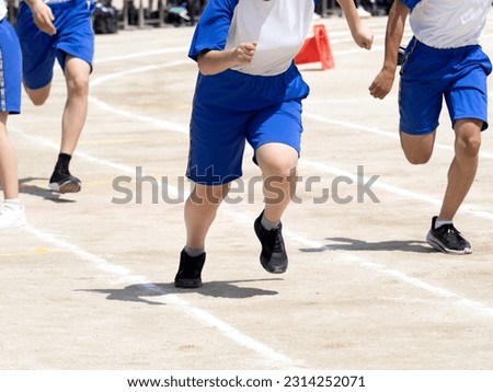 Junior high school students running the relay race of the athletic meet