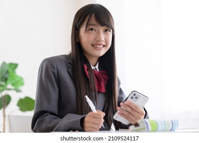 Junior high school students studying at home - Shutterstock ID 2109524117