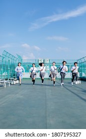 Junior High School Students And Teachers Running On The Rooftop