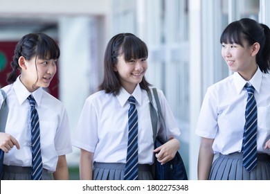 Junior High School Students Walking Side By Side In The Corridor