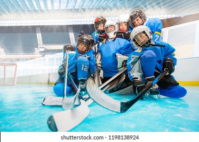 Junior Hockey Team With Goalie On Ice Rink