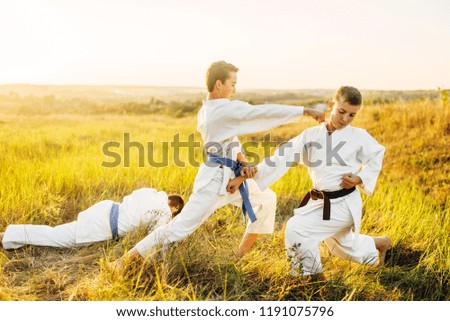 Junior karate fighters, outdoor training fight