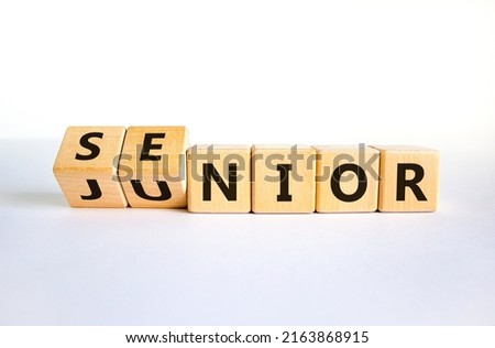 From junior to senior symbol. Turned cubes and changed the word 'junior' to 'senior'. Beautiful white background, copy space. Business and junior or senior concept.