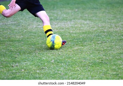 Junior Soccer Player Kicking The Ball