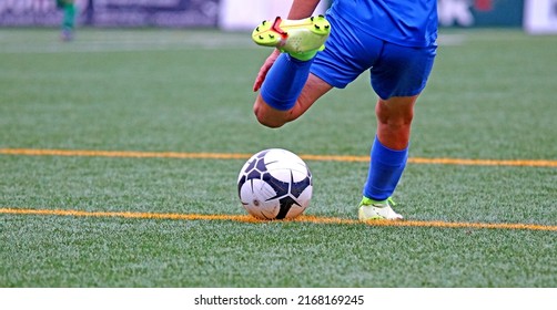 Junior Soccer Player Kicking The Ball