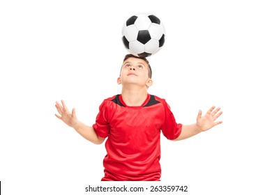 Junior Soccer Player Wearing Red Shirt Joggling With A Soccerball Isolated On White Background