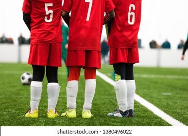 Junior Soccer Players Standing in a Wall. Free Kick Situation During Football Match. Players Wearing Red Soccer Jersey Shirts with Numbers on Back. Soccer Tournament Game - Powered by Shutterstock