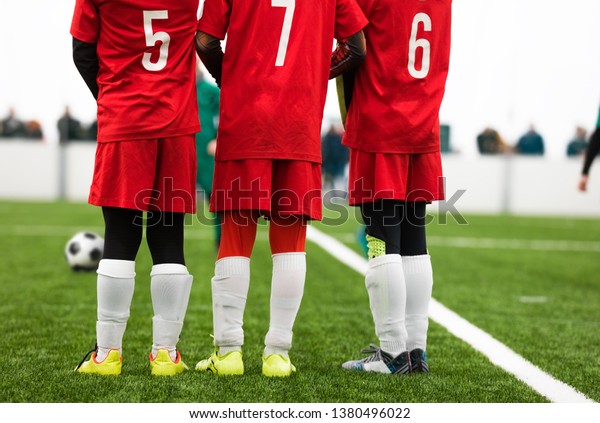 Junior Soccer
Players Standing in a Wall. Free Kick Situation During Football
Match. Players Wearing Red Soccer Jersey Shirts with Numbers on
Back. Soccer Tournament
Game