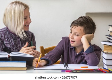 Junior student does homework with the help of his tutor. 