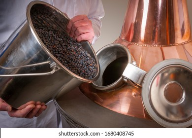 Juniper Berries Being Added To A Copper Gin Still