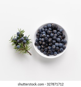 Juniper berries on white background, close-up