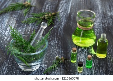 Juniper, Twig With Cones, Close Up,Bottle Of Cypress Tincture, Infusion, Oil