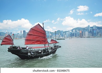 Junk Boat With Tourists In Hong Kong Victoria Harbour