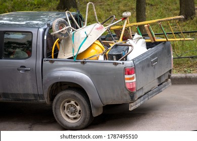 Junk In The Cargo Area Of ​​a Passenger Truck. Trolley And Ladder. Rear End Car