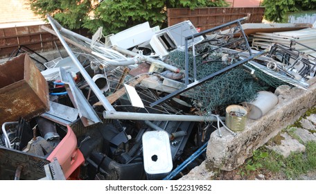 Junk Dealer With Many Old Pieces Of Rusted Iron And Metal