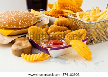 Junk food on white table. Fast carbohydrates not good for health, heart and skin Foto stock © 