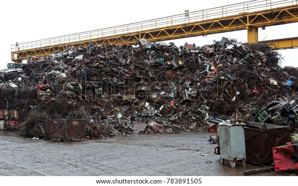 Junk yard with heap of\
metal waste