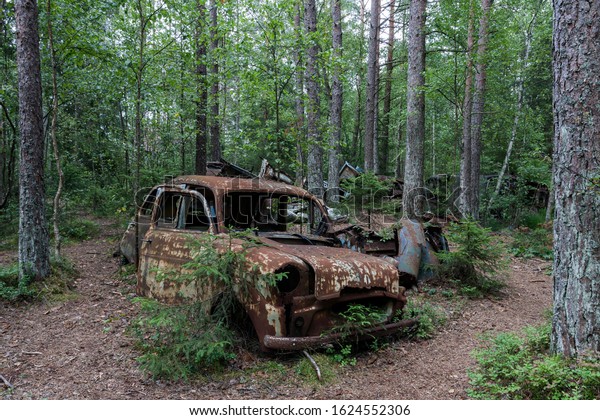 Junkyard in the forest, junk car, 40s, at Ryd,\
Småland, Sweden