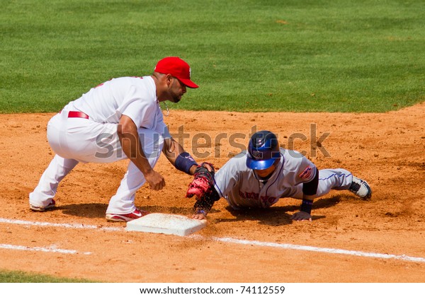 JUPITER, FL\
USA - MAR. 27: Met second baseman Chin-lung Hu gets back to first\
base during the New York Mets vs. St. Louis Cardinals spring\
training game March 27, 2010 in Jupiter,\
FL.