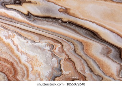 Jupiter onyx - natural polished stone slab in orange, brown, beige color, texture for perfect interior, background or other design project.