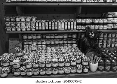 Jura, France - August 1, 2021:  Delicious Assortment Natural Honey And Artisan Confitures On Display In Local Food And Drink Specialties Shop. Sweet Lifestyle Background. Black White Historic Photo.