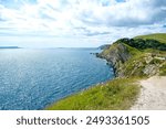 Jurassic coast view in Dorset near Lulworth Cove. Lulworth Cove cliffs view on a way to Durdle Door. The Jurassic Coast is a World Heritage Site on the English Channel coast of southern England.Dorset