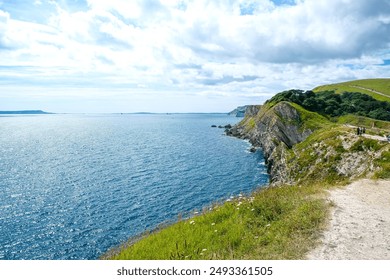 Jurassic coast view in Dorset near Lulworth Cove. Lulworth Cove cliffs view on a way to Durdle Door. The Jurassic Coast is a World Heritage Site on the English Channel coast of southern England.Dorset - Powered by Shutterstock