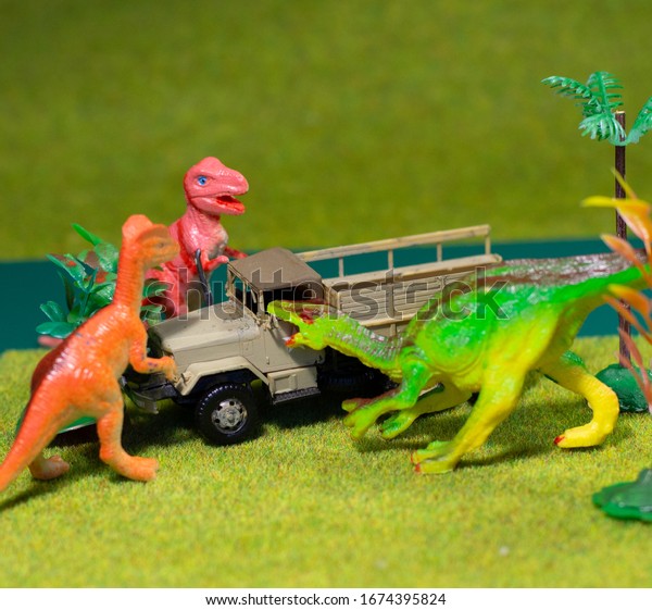 Jurassic\
World. Dinosaur figurines and car. Child\
Game.