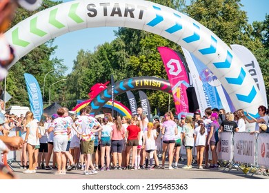 Jurmala, Kauguri, Latvia - August 14 2022: Close-up Of The Start Of Race On Track With Paints. Spectators Behind The Fence. The Color Run.