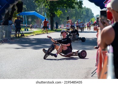 Jurmala, Kauguri, Latvia - August 14 2022: Close-up Of Race On Track With Paints. Spectators Behind The Fence. The Color Run.