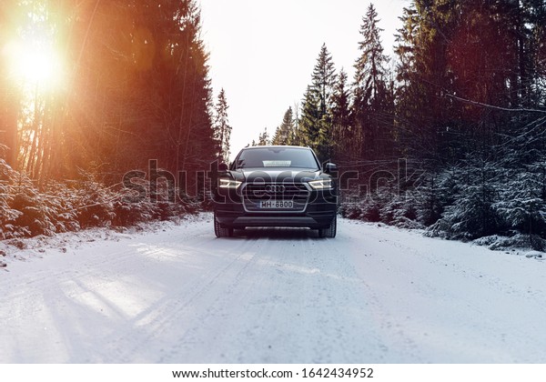 Jurmala,\
Latvia 11 February 2020 Audi Q5 Second generation. Stands on nature\
landscape with snow, winter time mood. Snow in forest countryside.\
Front car view, led lights on. Sun lens flares.\
