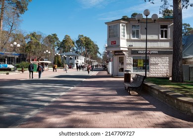 Jurmala. Latvia. April 18, 2022. Architecture of Jurmala has been preserved since the beginning of the 20th century. People walking along Jomas Street on sunny spring day.