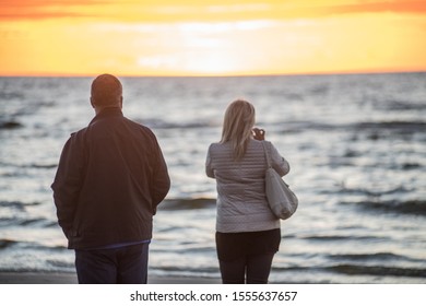 Jurmala, Latvia. Sunset at the Baltc sea. Man and woman at sunset