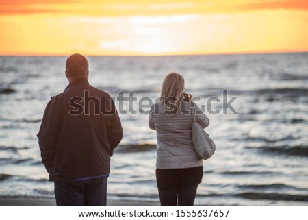 Jurmala, Latvia. Sunset at the Baltc sea. Man and woman at sunset