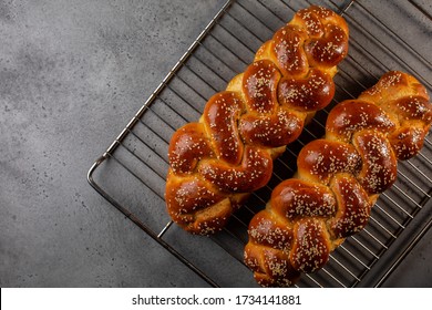 Just baked homemade Challah -  special bread in Jewish cuisine.Main ingredients are eggs, white flour, water, sugar, salt  and yeast. Decorated  with sesame and poppy seeds. Copy space.