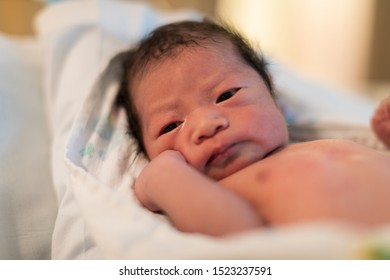 Just Born Asian Baby Laying In The Infant Bassinet Basket At Hospital