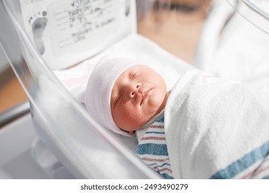 Just born swaddled newborn baby at the hospital. Baby's birth day - Powered by Shutterstock