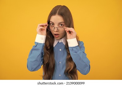 Just curious. Curious girl in eyeglasses. Nerdy-looking kid yellow background. Back to school